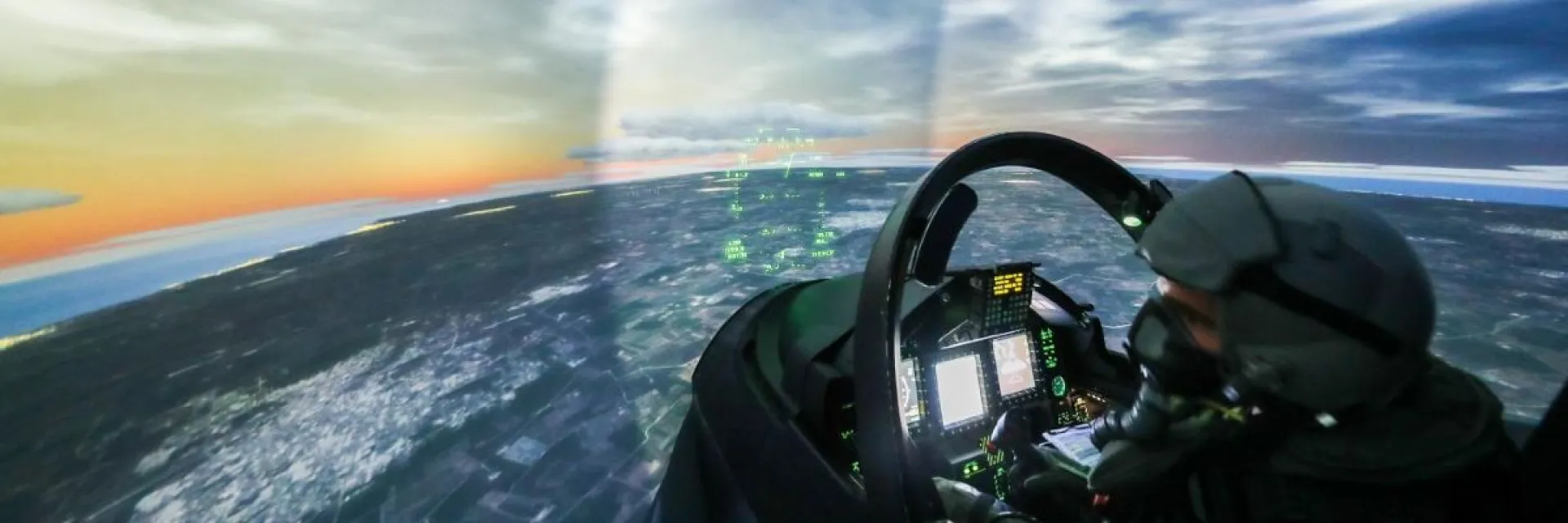 Pilot operating a sophisticated flight simulator with panoramic digital displays, showcasing defense innovation, aerospace technology, and strategic security capabilities within Europe’s critical technology sectors.